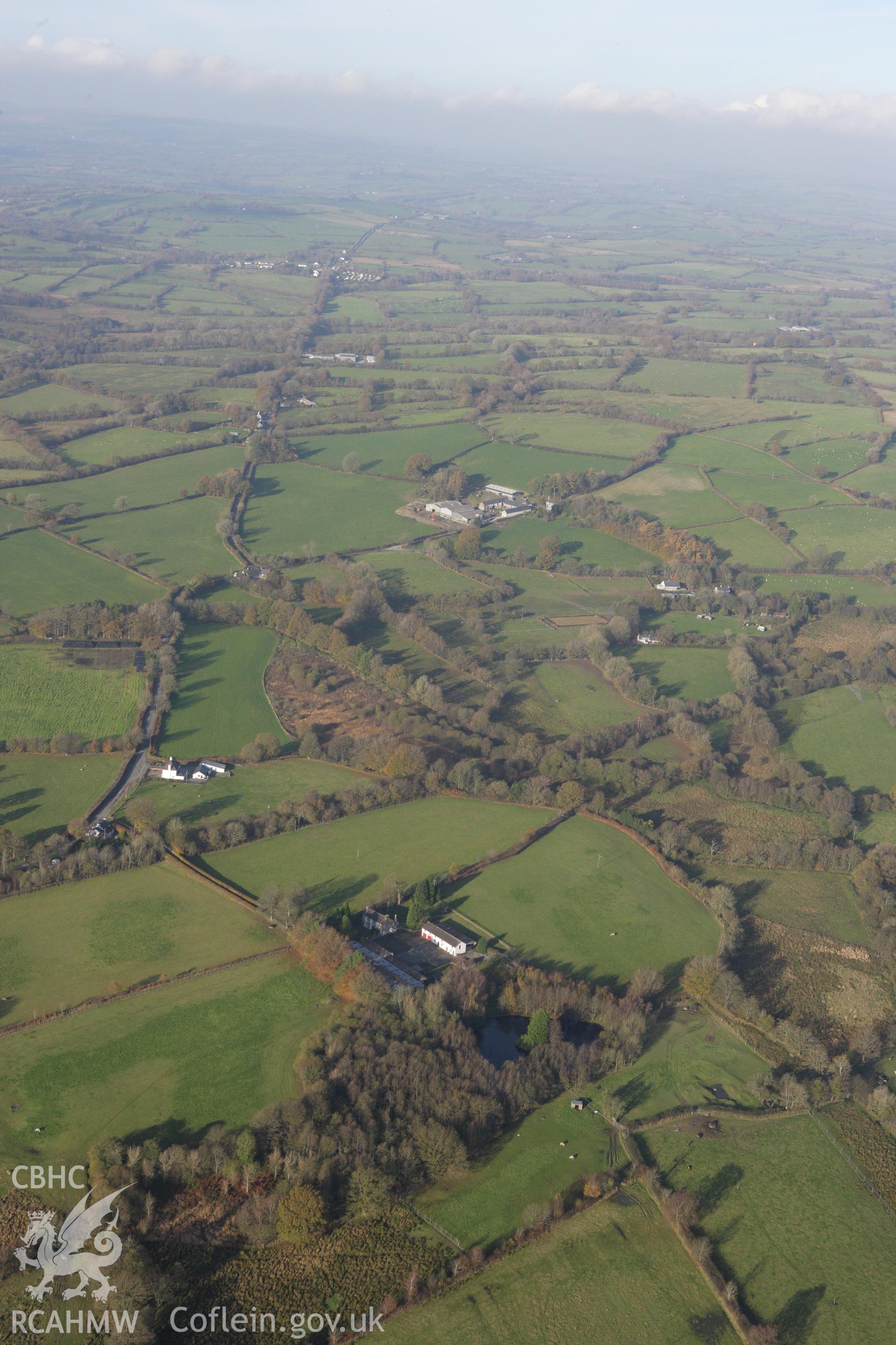 RCAHMW colour oblique aerial photograph of Llanio Roman Fort with Sarn Helen to the north. Taken on 09 November 2009 by Toby Driver