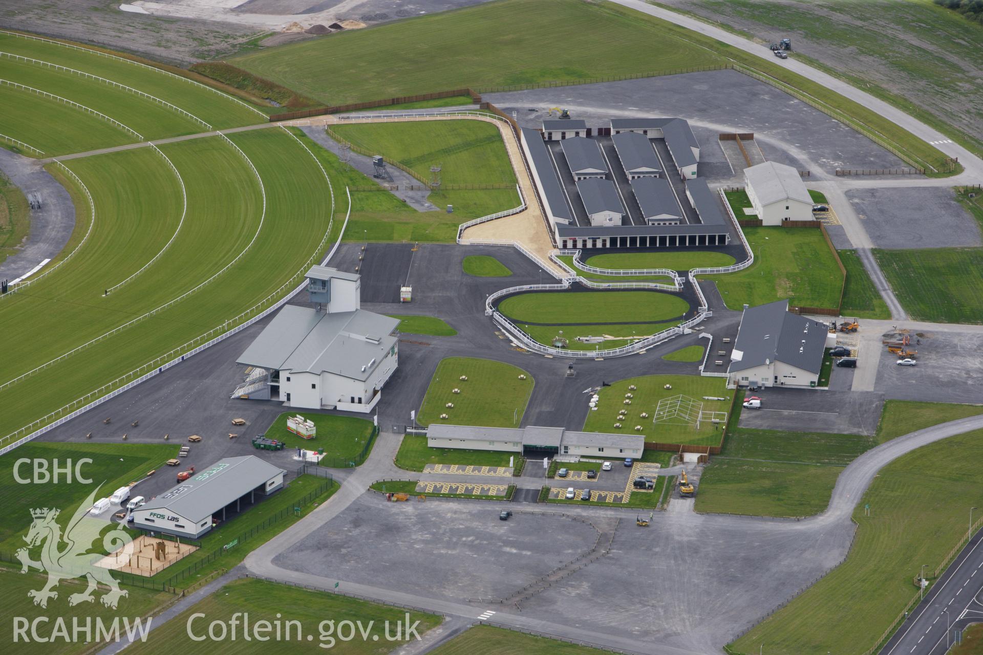 RCAHMW colour oblique aerial photograph of Ffos Las Racecourse. Taken on 09 July 2009 by Toby Driver