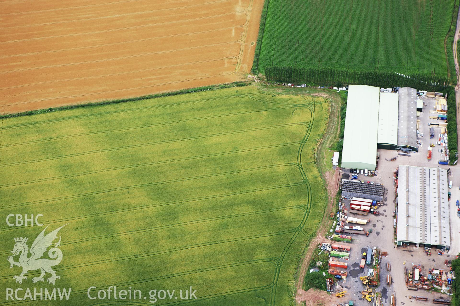 RCAHMW colour oblique aerial photograph of Llancayo Farm Defended Enclosure. Taken on 09 July 2009 by Toby Driver