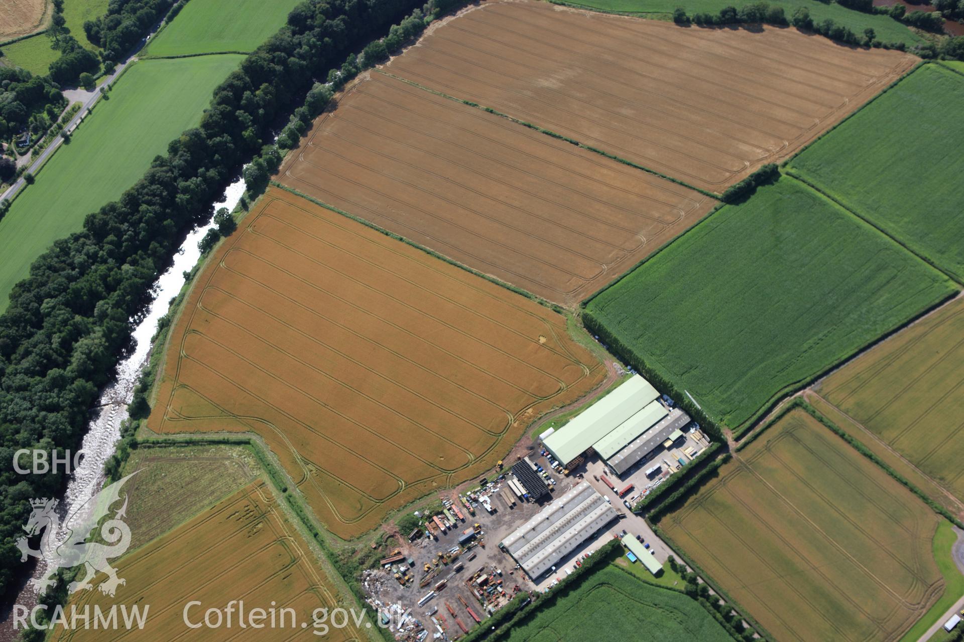 RCAHMW colour oblique aerial photograph of Llancayo Farm Defended Enclosure. Taken on 23 July 2009 by Toby Driver