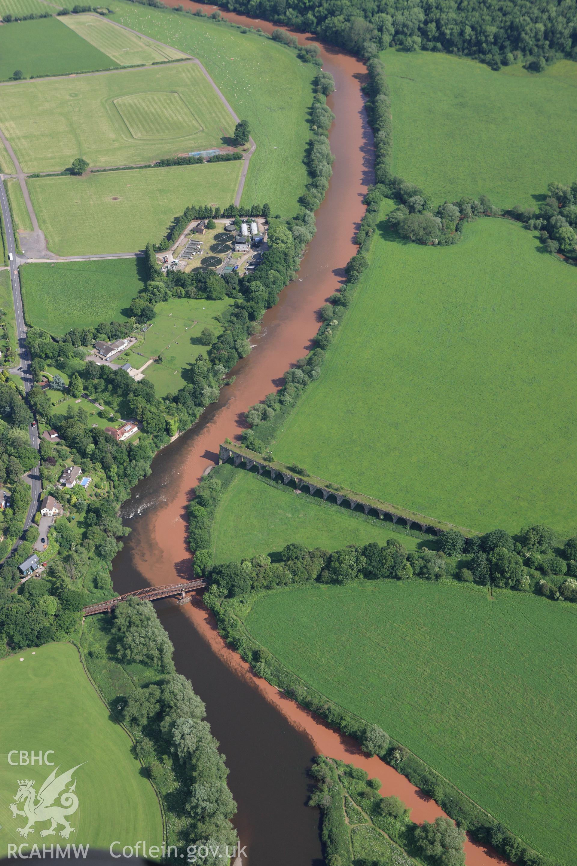 RCAHMW colour oblique aerial photograph of river patterns close to the Wye Bridge on the Hereford, Ross and Gloucester Railway in Monmouth. Taken on 11 June 2009 by Toby Driver