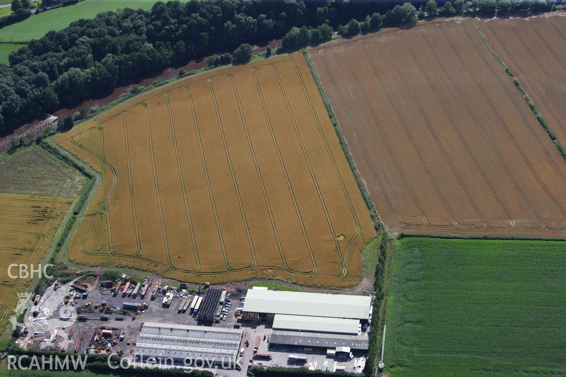 RCAHMW colour oblique aerial photograph of Llancayo Farm Defended Enclosure. Taken on 23 July 2009 by Toby Driver