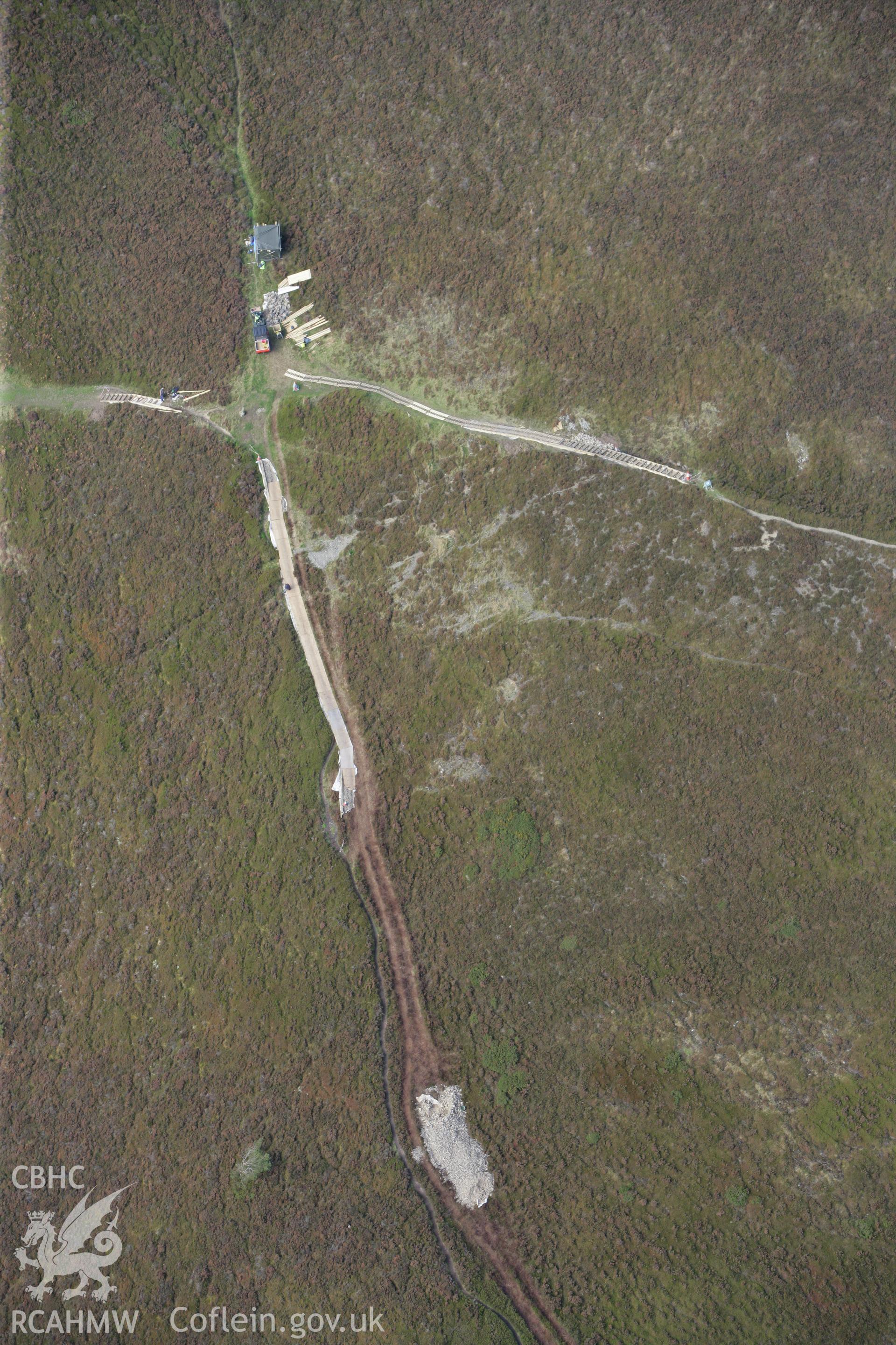 RCAHMW colour oblique aerial photograph of Foel Fenlli Hillfort showing a path being built. Taken on 13 October 2009 by Toby Driver