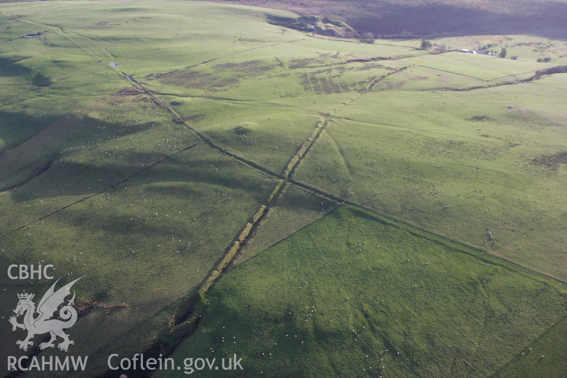 RCAHMW colour oblique aerial photograph of Two Tumps Dyke II and nearby barrows. Taken on 10 December 2009 by Toby Driver