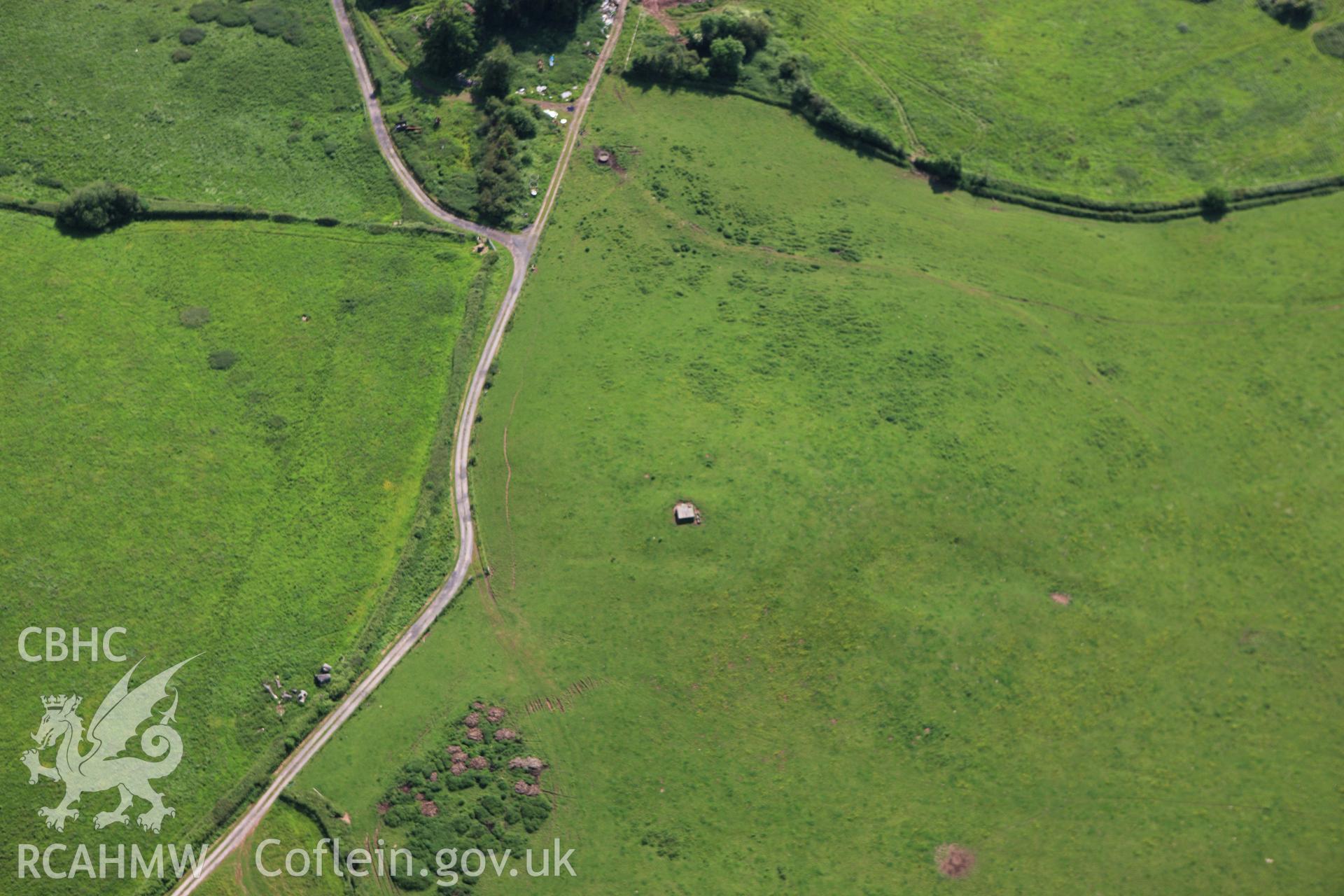 RCAHMW colour oblique aerial photograph of Civil War siege earthworks to the north-east of Raglan Castle. Taken on 11 June 2009 by Toby Driver