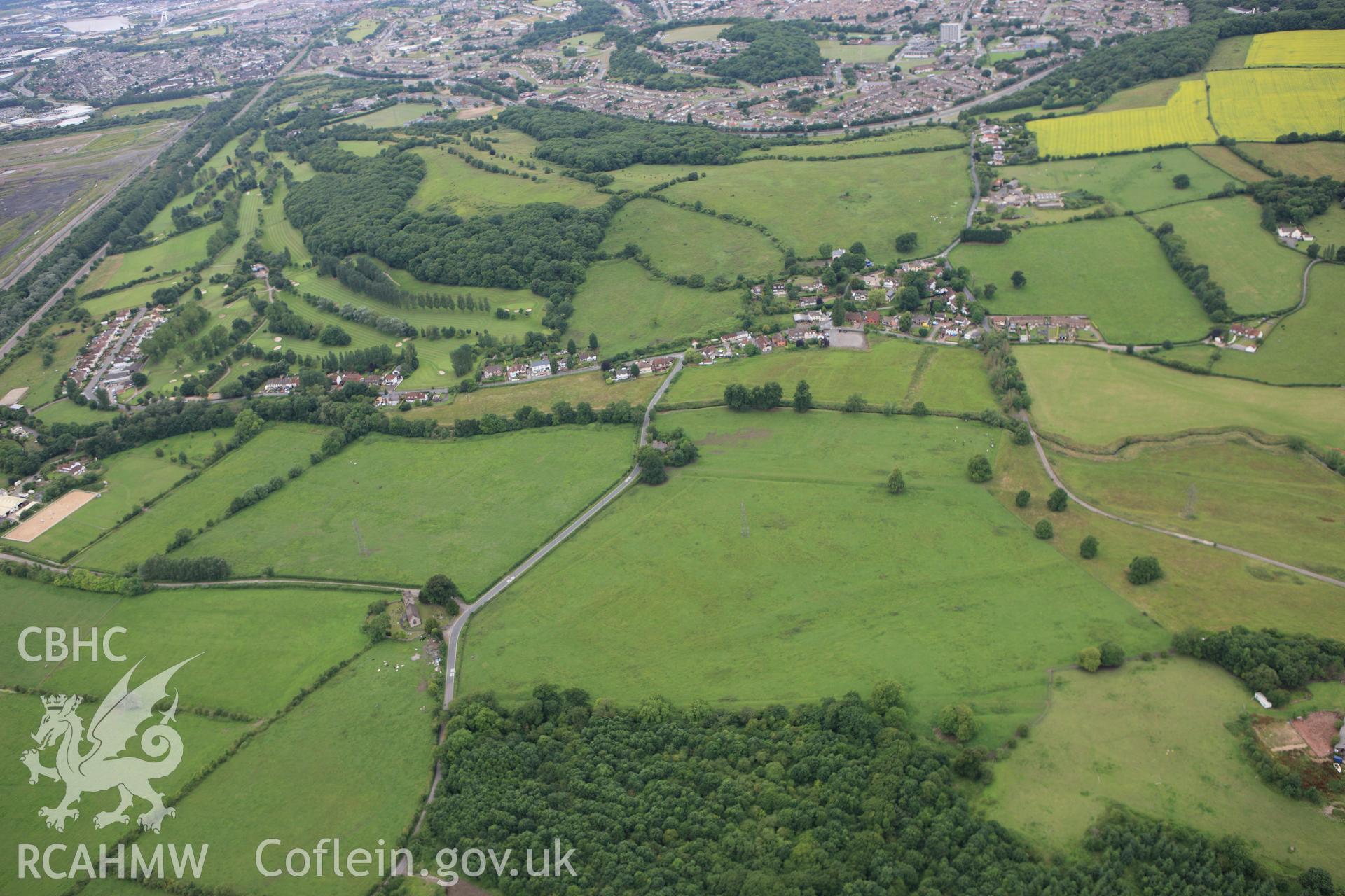RCAHMW colour oblique aerial photograph of St Mary, Llanwern. A wide view from the east. Taken on 09 July 2009 by Toby Driver