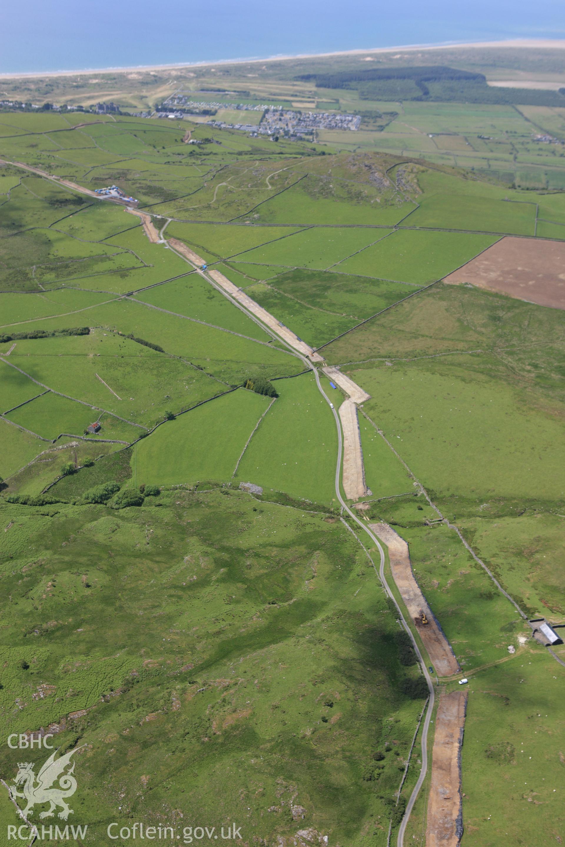 RCAHMW colour oblique aerial photograph of Rhiwgoch Water Treatment Works, Harlech, showing the line of a water pipe. Taken on 16 June 2009 by Toby Driver