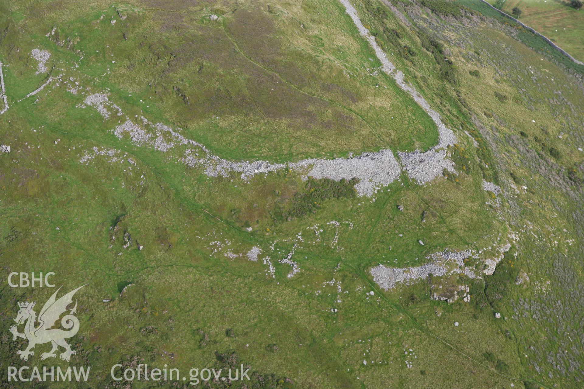 RCAHMW colour oblique aerial photograph of Pen-y-Gaer Hillfort. Taken on 06 August 2009 by Toby Driver