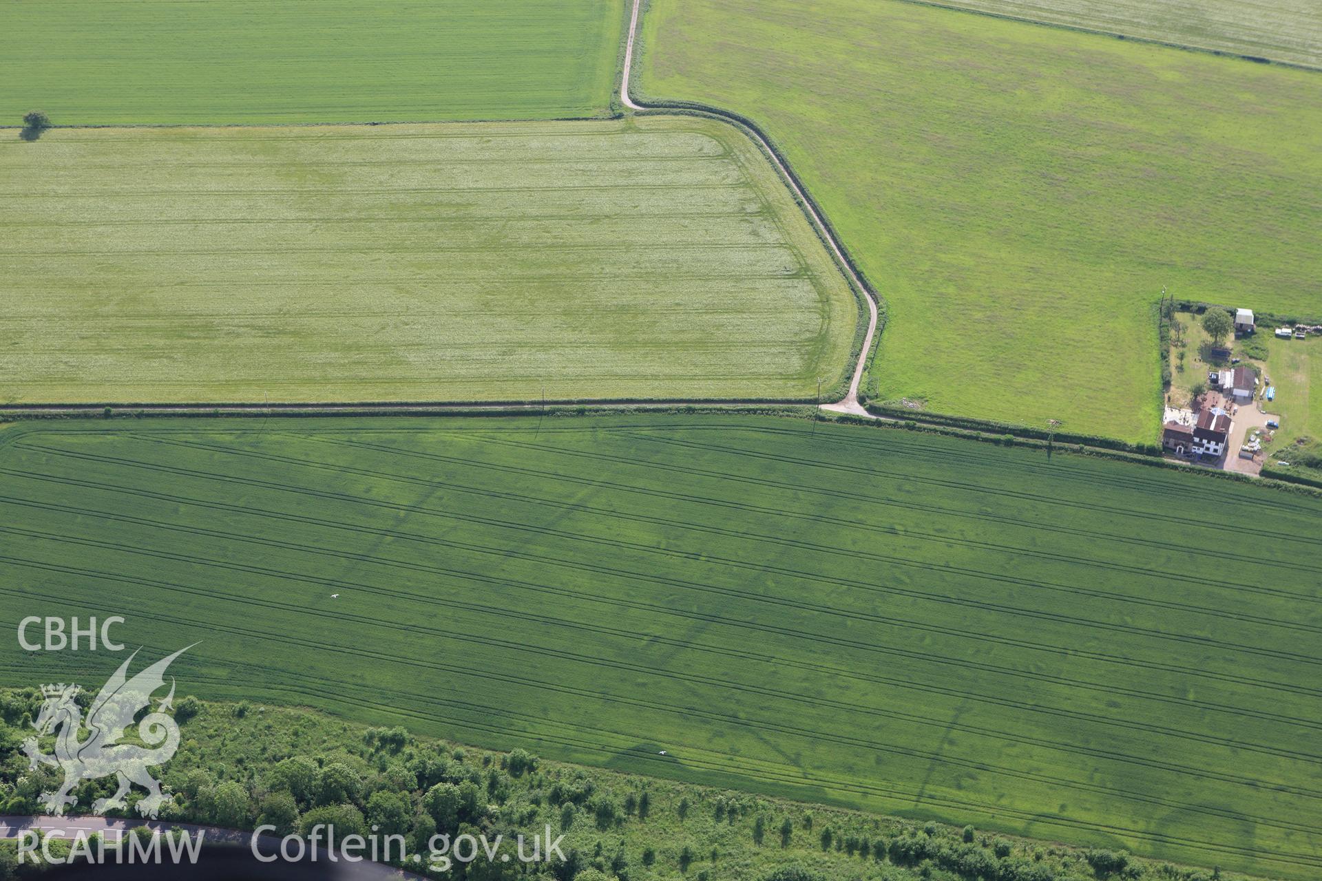 RCAHMW colour oblique aerial photograph of Trewen enclosure complex and ancient field system. Taken on 11 June 2009 by Toby Driver