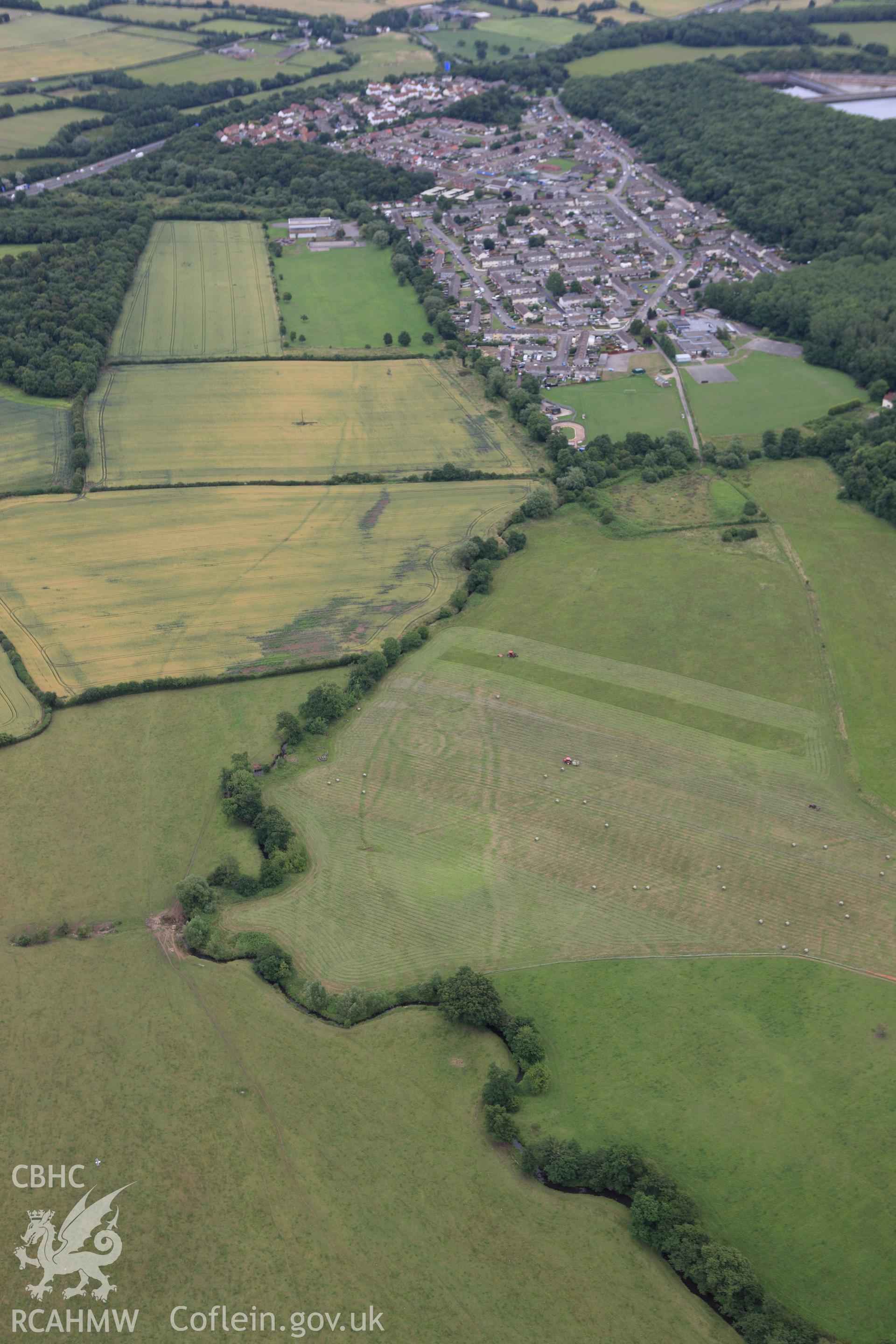 RCAHMW colour oblique aerial photograph of Monks Ditch showing cropmarks of strip field systems. Taken on 09 July 2009 by Toby Driver