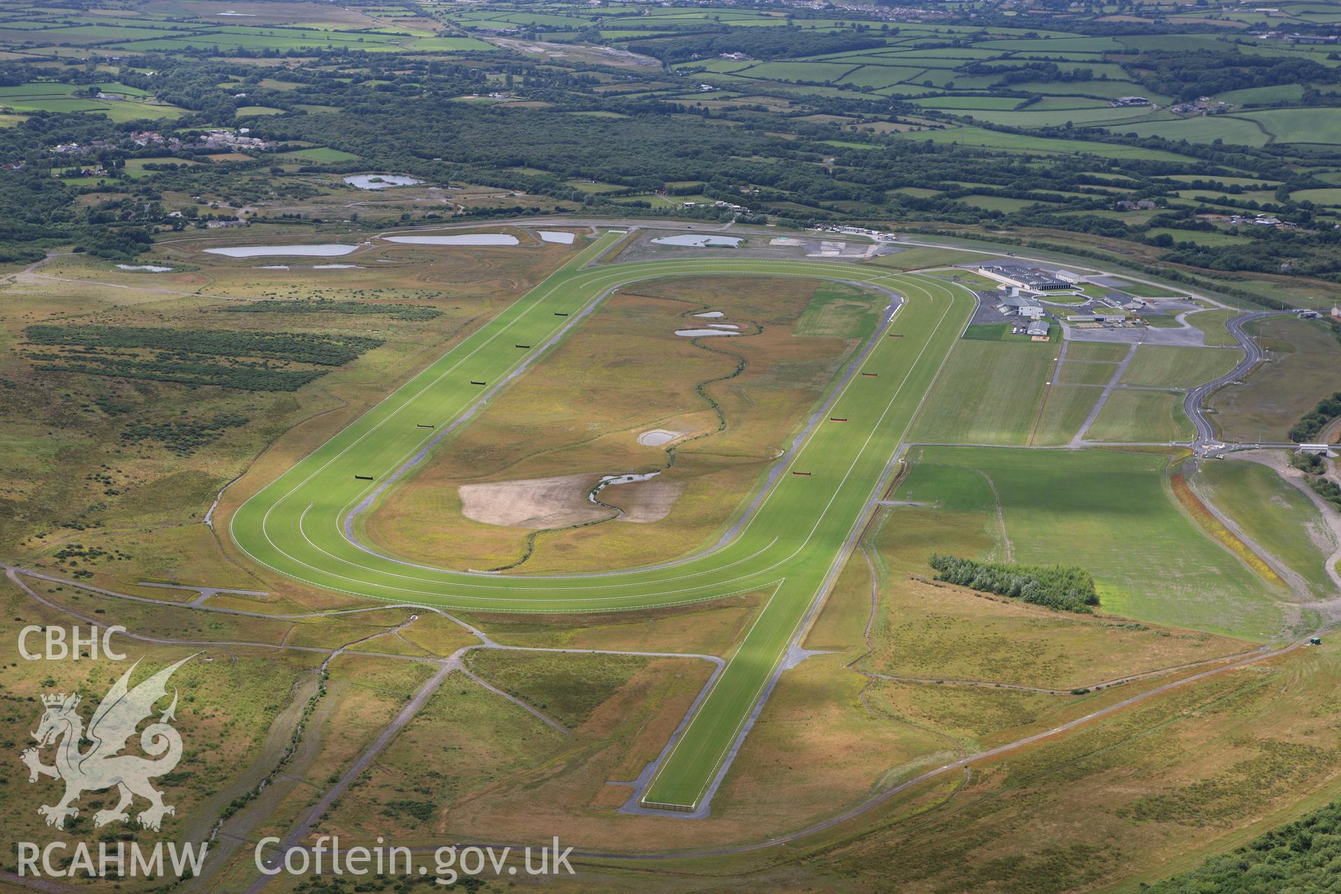 RCAHMW colour oblique aerial photograph of Ffos Las Racecourse. Taken on 09 July 2009 by Toby Driver