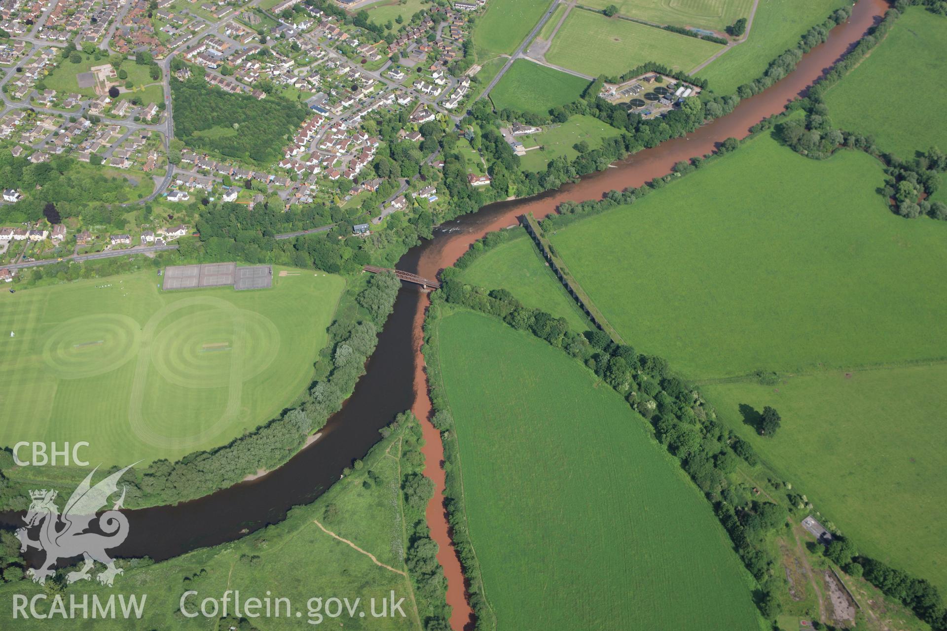 RCAHMW colour oblique aerial photograph of river patterns close to the Wye Bridge on the Hereford, Ross and Gloucester Railway in Monmouth. Taken on 11 June 2009 by Toby Driver