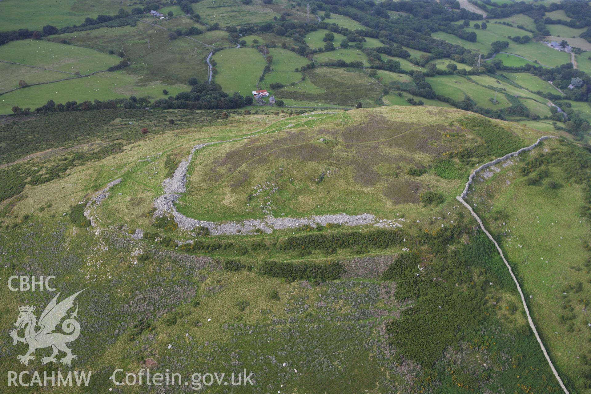 RCAHMW colour oblique aerial photograph of Pen-y-Gaer Hillfort. Taken on 06 August 2009 by Toby Driver