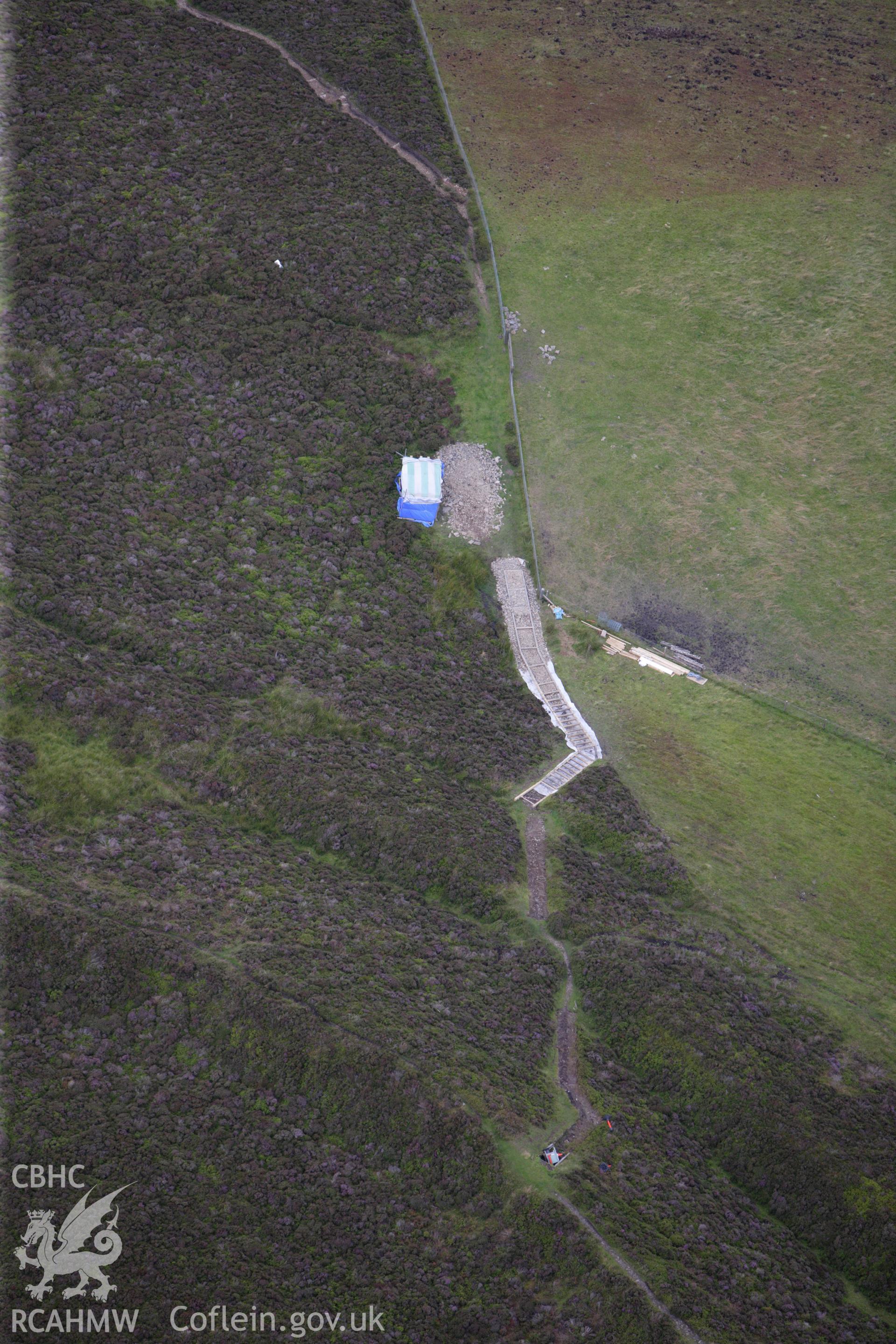 RCAHMW colour oblique aerial photograph of Foel Fenlli Hillfort showing repair work on the path on the north-east side. Taken on 30 July 2009 by Toby Driver