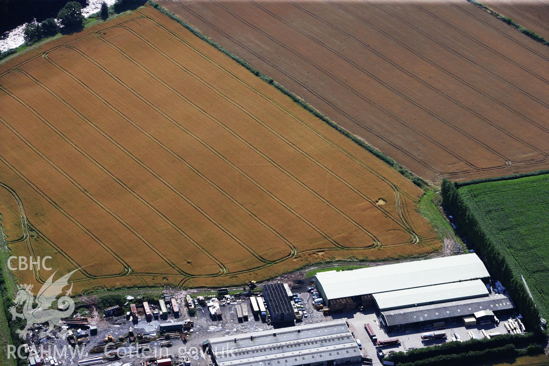 RCAHMW colour oblique aerial photograph of Llancayo Farm Defended Enclosure. Taken on 23 July 2009 by Toby Driver