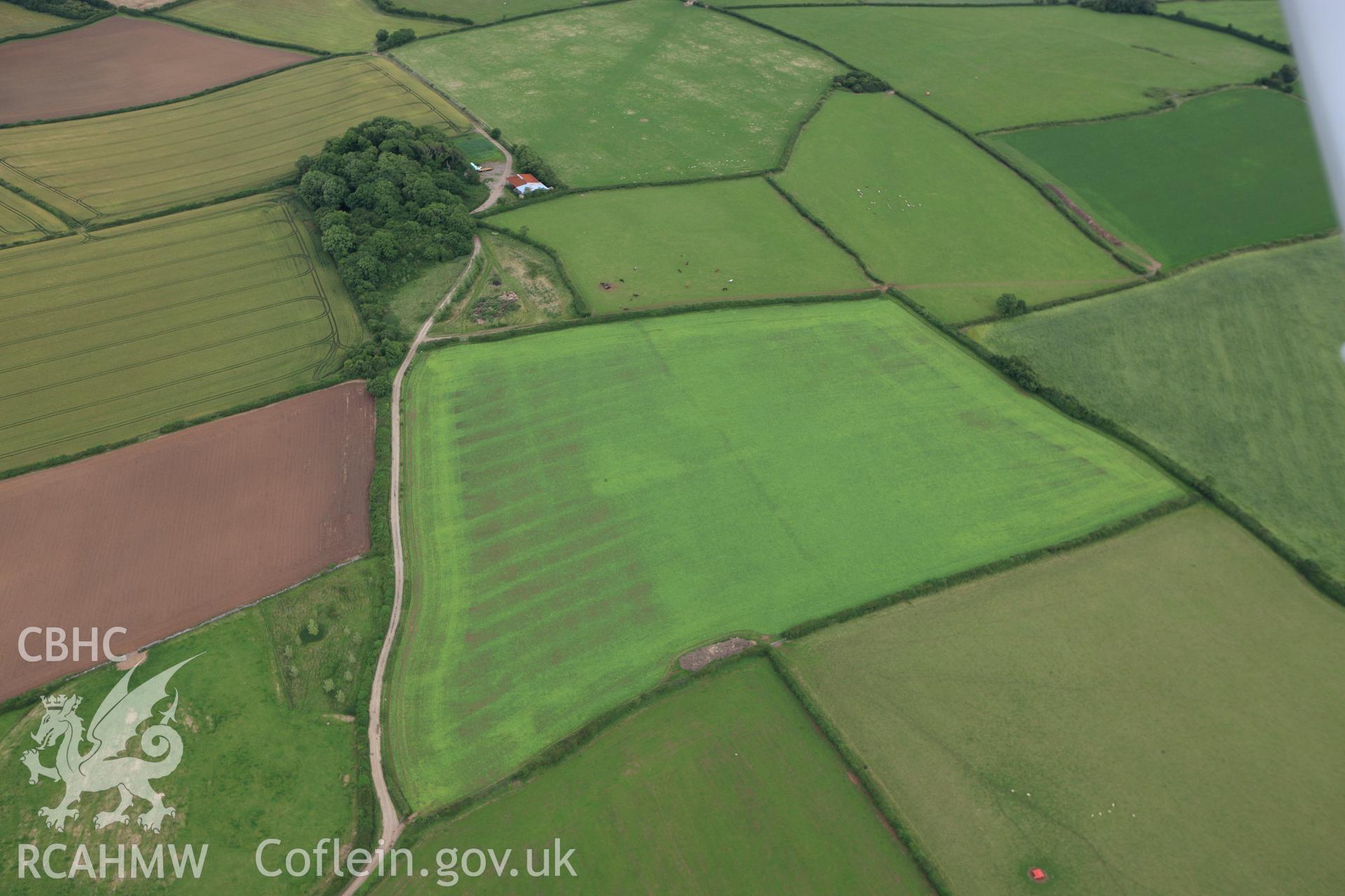 RCAHMW colour oblique aerial photograph of Corntown Enclosure. Taken on 09 July 2009 by Toby Driver
