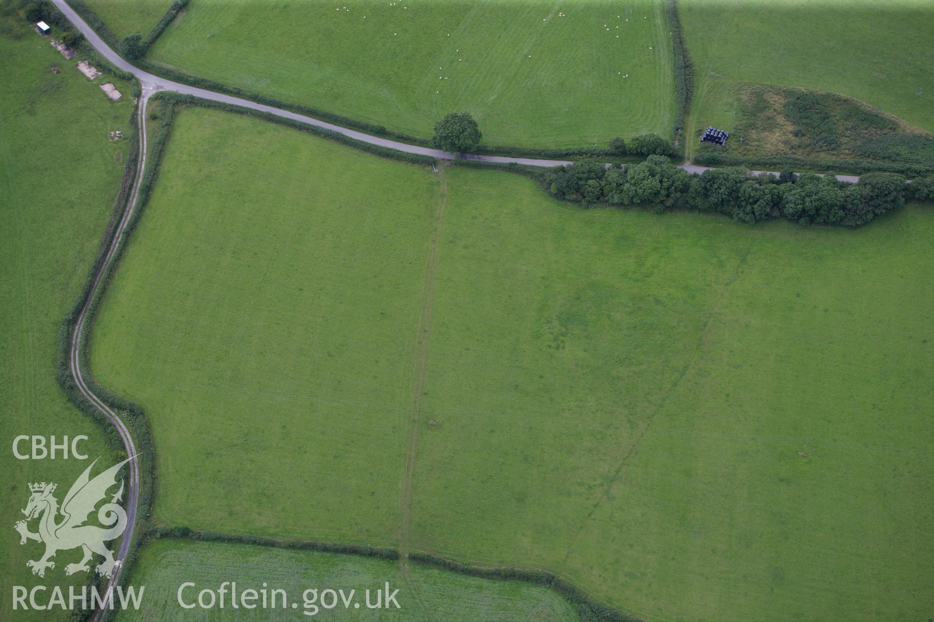 RCAHMW colour oblique aerial photograph of Bryn Fadog Enclosure. Taken on 30 July 2009 by Toby Driver