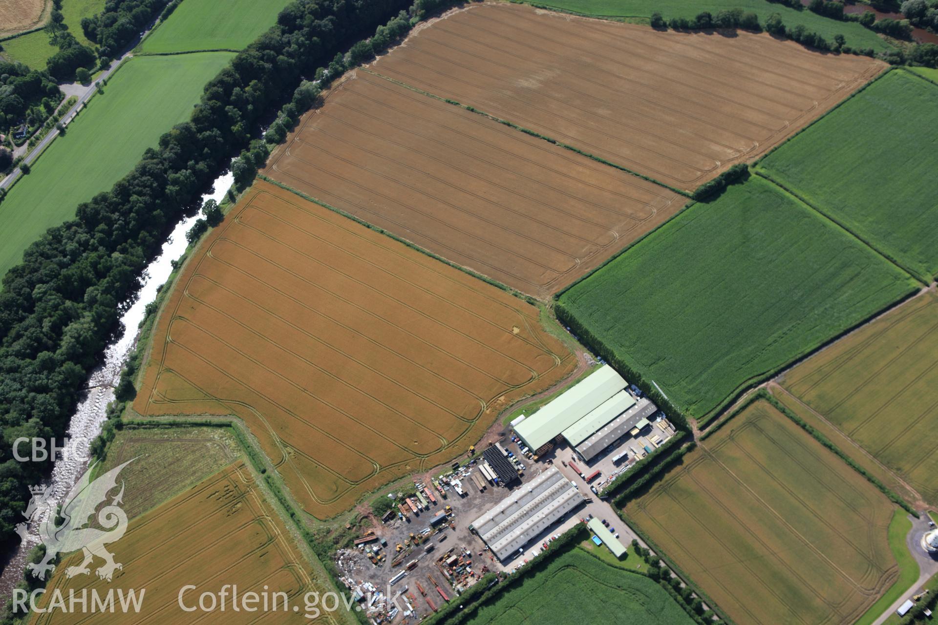 RCAHMW colour oblique aerial photograph of Llancayo Farm Defended Enclosure. Taken on 23 July 2009 by Toby Driver
