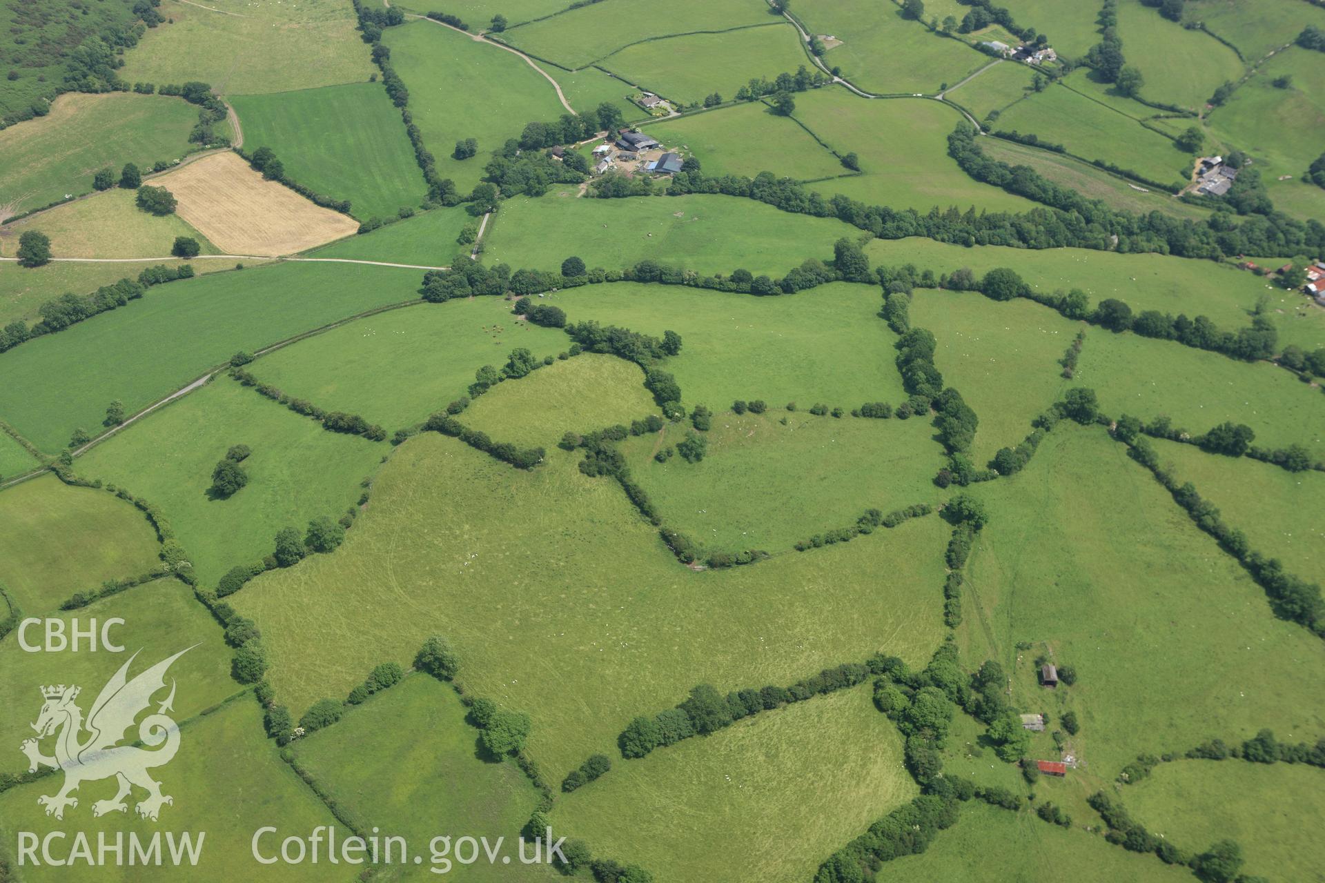 RCAHMW colour oblique aerial photograph of the landscape surrounding Cwm Mawr Axe Factory at Hyssington. Taken on 29 June 2009 by Toby Driver