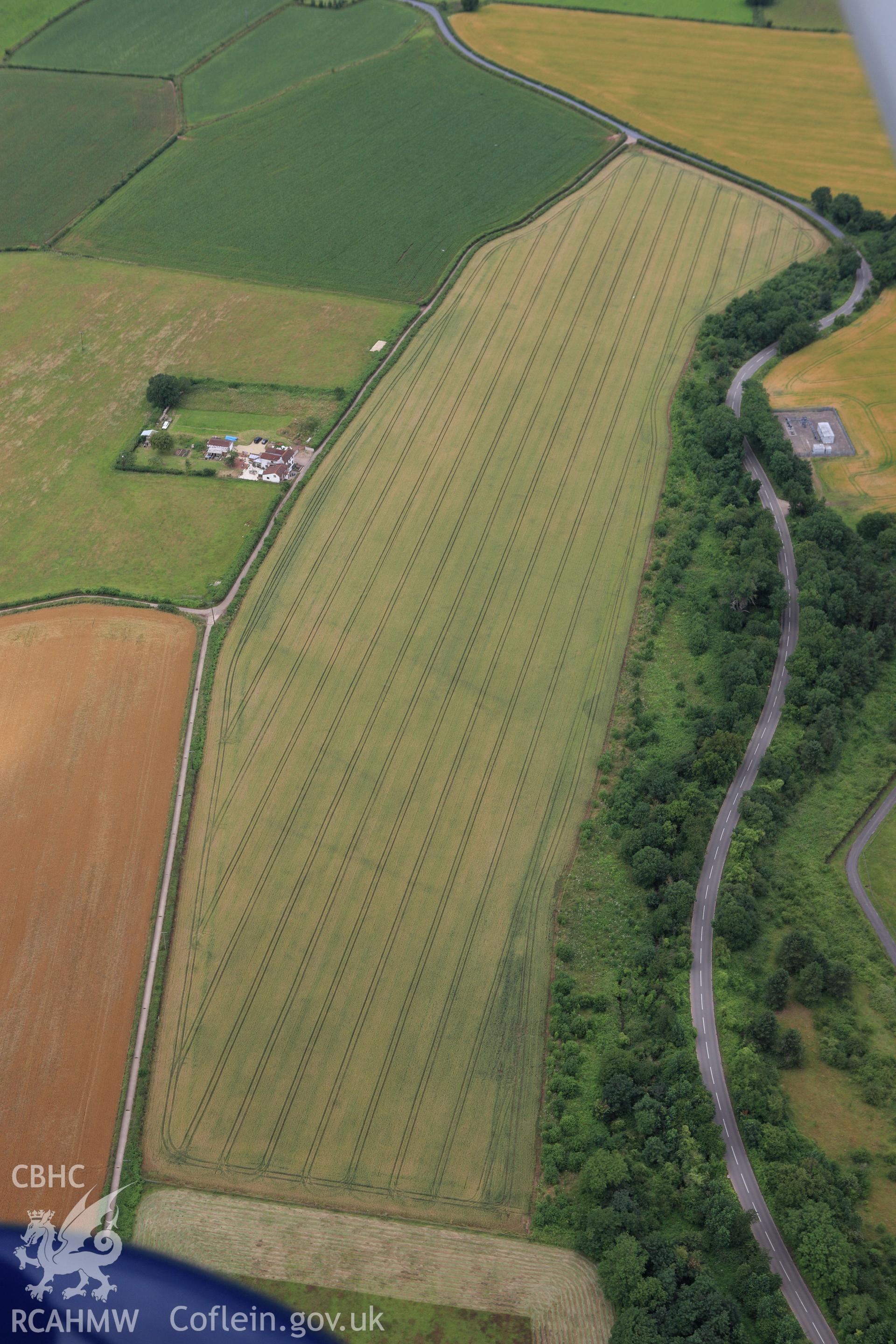 RCAHMW colour oblique aerial photograph of Trewen enclosure complex and ancient field system. Taken on 09 July 2009 by Toby Driver