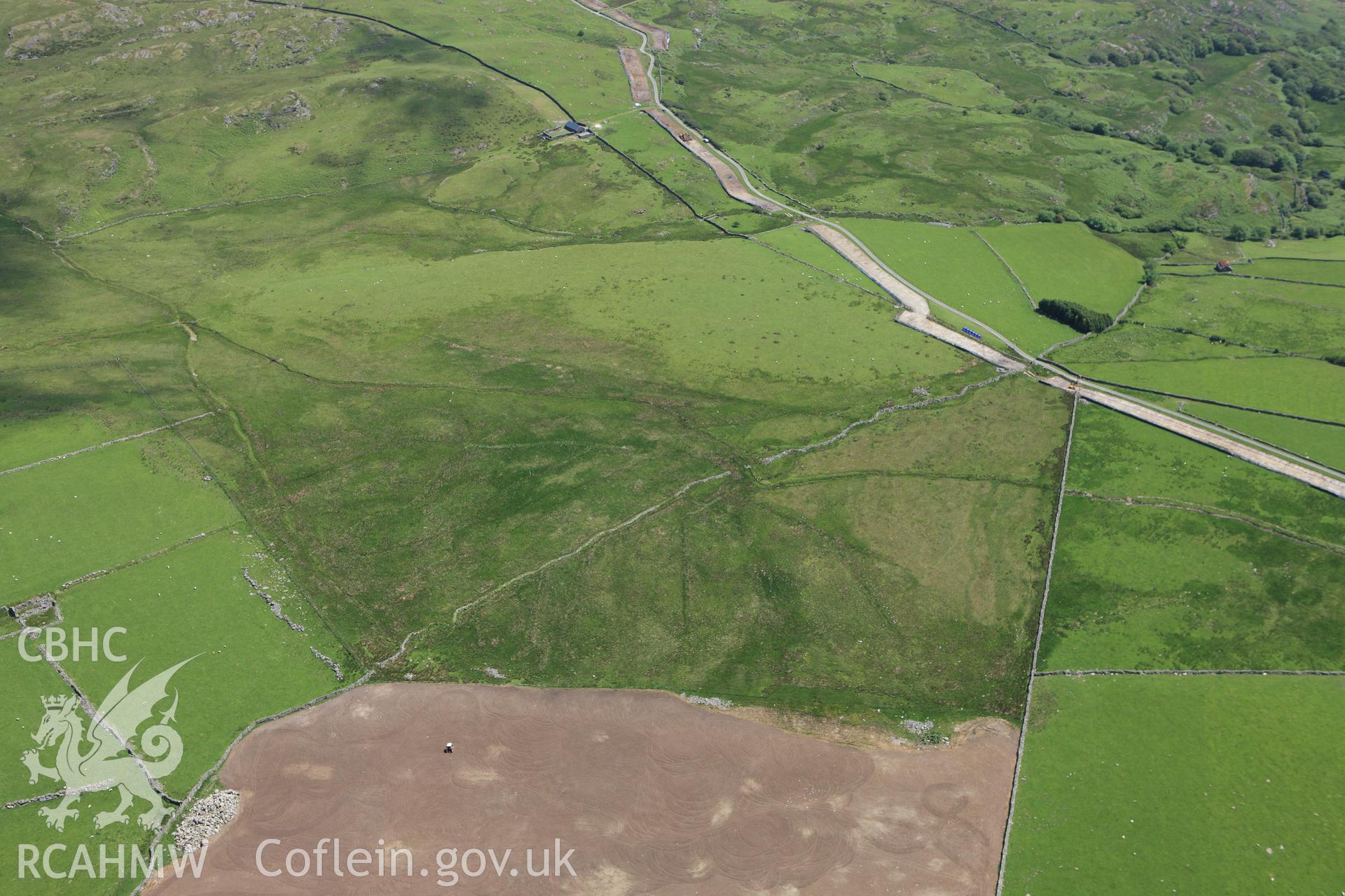 RCAHMW colour oblique aerial photograph of Rhiwgoch Water Treatment Works, Harlech, showing the line of a water pipe. Taken on 16 June 2009 by Toby Driver