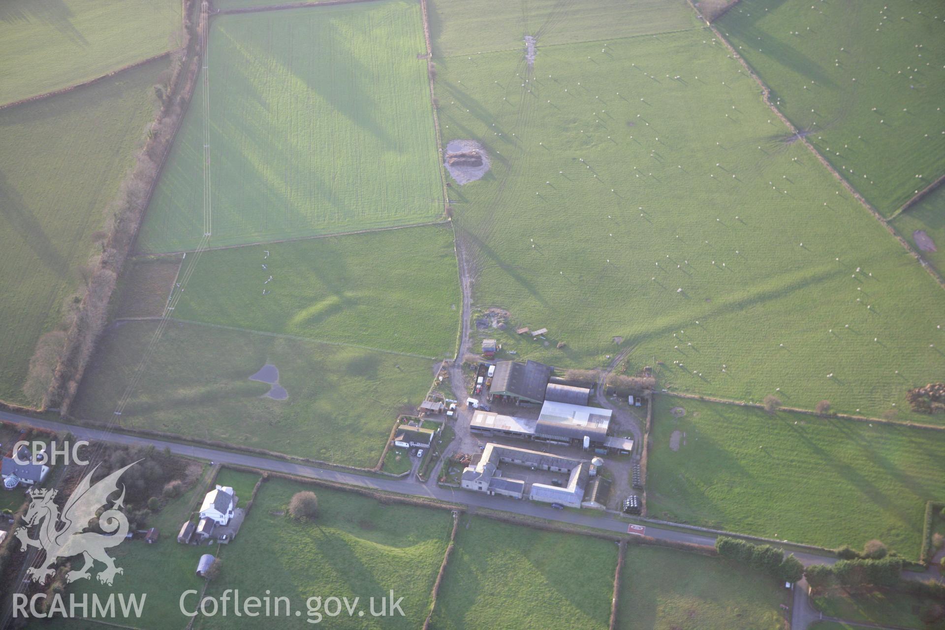 RCAHMW colour oblique aerial photograph of a circle, barrow and linear earthworks at Holywell. Taken on 10 December 2009 by Toby Driver