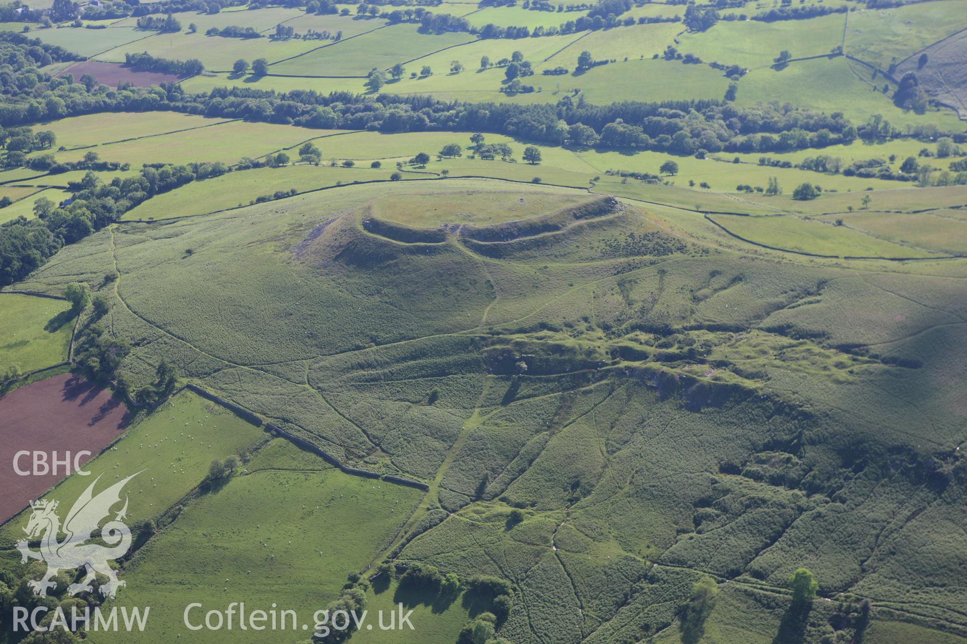 RCAHMW colour oblique aerial photograph of Crug Hywel Camp. Taken on 11 June 2009 by Toby Driver