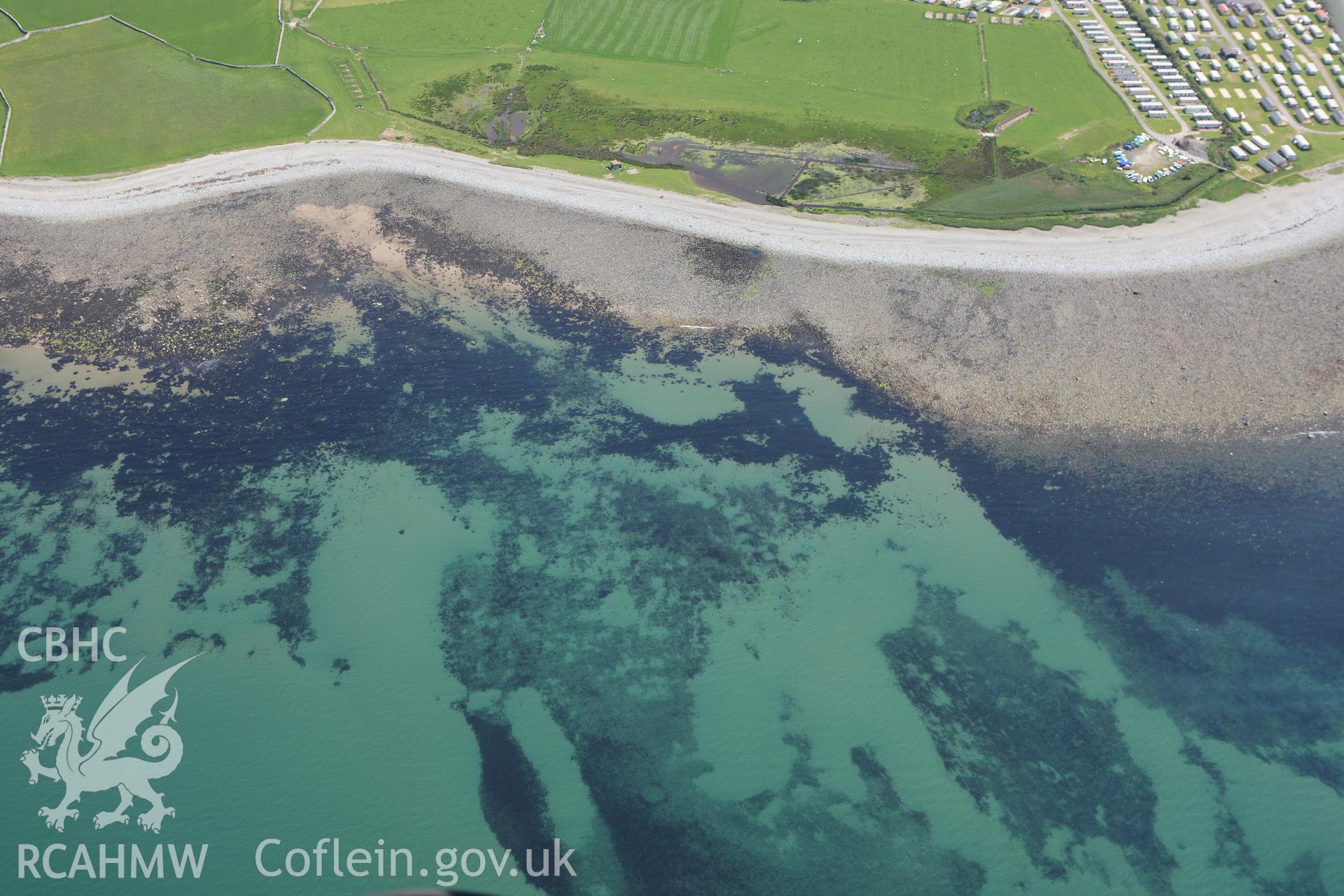 RCAHMW colour oblique aerial photograph of intertidal features near Llwyngwril Fish Trap I. Taken on 02 June 2009 by Toby Driver